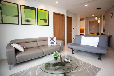 a living room with a couch and a glass table at Vortex KLCC by LSA in Kuala Lumpur