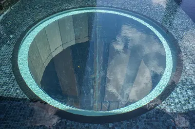 a reflection of a person in a pool of water at Happy holiday at Lucentia Residence in Kuala Lumpur