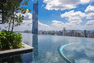 a infinity pool with a view of a city at Happy holiday at Lucentia Residence in Kuala Lumpur