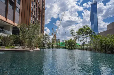 a river in the middle of a city with buildings at Happy holiday at Lucentia Residence in Kuala Lumpur