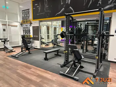 a gym with several treadmills and machines in a room at Klcc Quill Cozy& Chill Suite 3-5Pax HD1080 Netflix in Kuala Lumpur