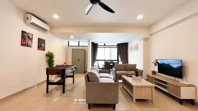 a living room with a couch and a tv at Fahrenheit 88 Bukit Bintang by Manhattan Group in Kuala Lumpur