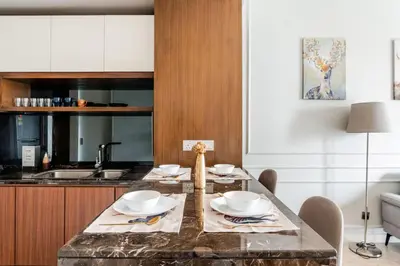 a kitchen with a table with dishes on it at Designer Luxury Condo Near Bukit Bintang in Kuala Lumpur