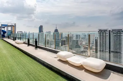 a row of white seats on the roof of a building at Designer Luxury Condo Near Bukit Bintang in Kuala Lumpur