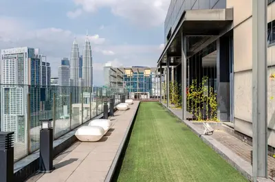 a balcony with grass on the side of a building at Designer Luxury Condo Near Bukit Bintang in Kuala Lumpur