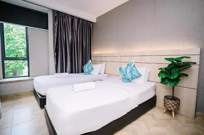 a hotel room with two beds and a window at Swing & Pillows - TAR UMT Setapak in Kuala Lumpur