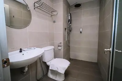 a bathroom with a toilet and a sink and a mirror at Swing & Pillows - TAR UMT Setapak in Kuala Lumpur