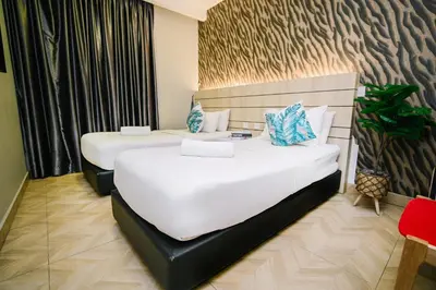 a hotel room with two beds in a room at Swing & Pillows - TAR UMT Setapak in Kuala Lumpur
