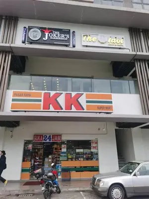 a kx store with a motorcycle parked in front of it at ISYAK Homestay Cheras M Vertika KL in Kuala Lumpur