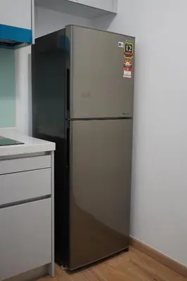a refrigerator in the corner of a kitchen at Riveria City KL Sentral by Nest Suite in Kuala Lumpur