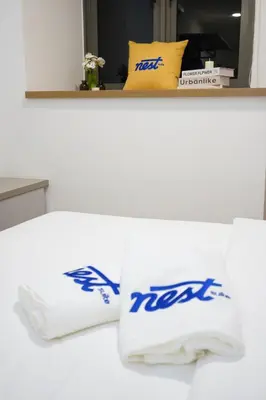 a white bed with two pillows on top of it at Riveria City KL Sentral by Nest Suite in Kuala Lumpur