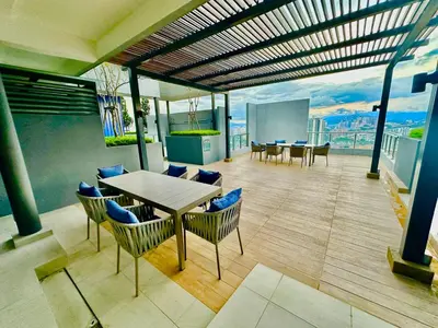 a room with a table and chairs on a building at Neu Suites by Cozy Homes Near Gleneagles, KLCC & LRT in Kuala Lumpur