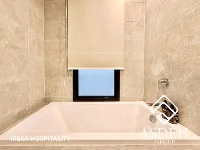a bath tub in a bathroom with a window at KaMi Mont Kiara Residences & Hotel by Ireka in Kuala Lumpur