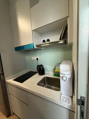 a kitchen counter with a sink and a toaster at Nest Suites By KL in Kuala Lumpur