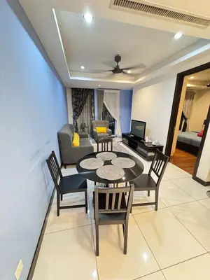 a living room with a table and chairs and a couch at Casa residency by relaxhome in Kuala Lumpur