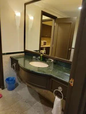 a bathroom with a sink and a large mirror at Twobedroom Hotel Apartment At Times Square Kuala Lumpur in Kuala Lumpur