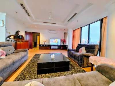 a living room with couches and a flat screen tv at Twobedroom Hotel Apartment At Times Square Kuala Lumpur in Kuala Lumpur
