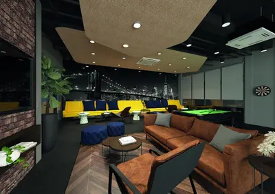 a living room with couches and ping pong tables at Suite16 Kuala Lumpur in Kuala Lumpur