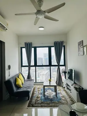 a living room with a couch and a ceiling fan at In