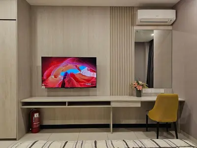 a living room with a television on a wall at Societe Hartamas, Mont Kiara, Kuala Lumpur Golf in Kuala Lumpur
