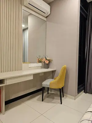 a bathroom with a yellow chair and a mirror at Societe Hartamas, Mont Kiara, Kuala Lumpur Golf in Kuala Lumpur