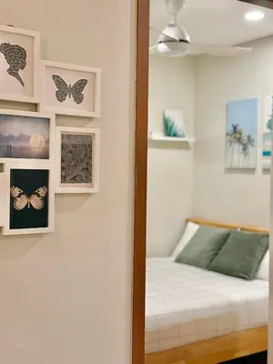 a bedroom with a bed and pictures on the wall at Sky Suites Klcc By Stayner in Kuala Lumpur