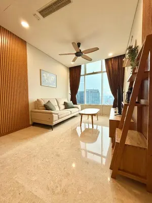 a living room with a couch and a ceiling fan at Sky Suites Klcc By Stayner in Kuala Lumpur