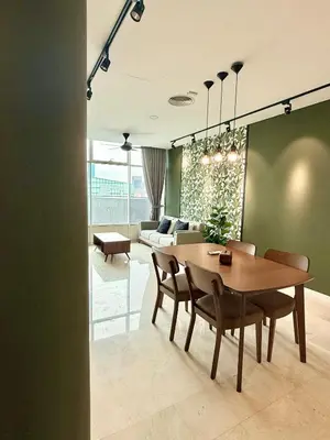 a dining room with a table and a couch at Sky Suites Klcc By Stayner in Kuala Lumpur