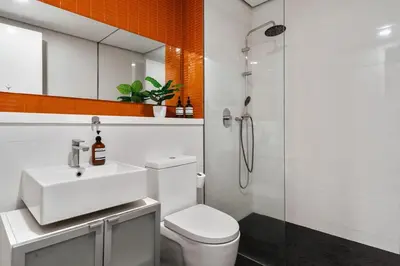 a bathroom with a toilet and a sink and a shower at Arcoris Mont Kiara in Kuala Lumpur