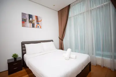 a bedroom with a bed and a large window at Soho Suites Pavilion by LSA in Kuala Lumpur
