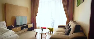 a living room with a couch and a tv and a table at Soho Suites Pavilion by LSA in Kuala Lumpur