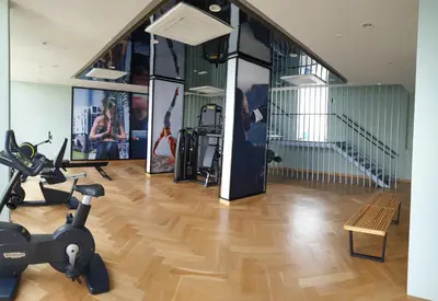 a gym with treadmills and exercise equipment and a staircase at KL Mont Kiara The Ooak Entire Unit in Kuala Lumpur