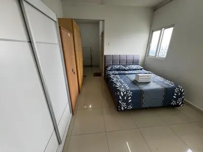 a small bedroom with a bed and a hallway at Maxim City Lights in Kuala Lumpur
