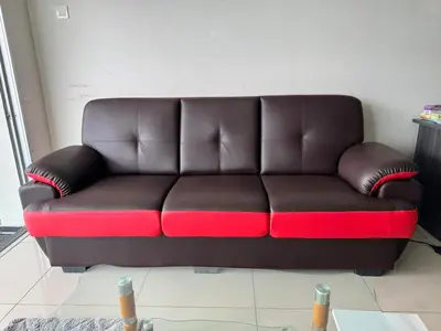 a brown and red couch in a living room at Maxim City Lights in Kuala Lumpur