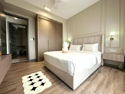 a bedroom with a large white bed and a bathroom at Agile Bukit Bintang TRX KL by Lilbean Space - 2B1R in Kuala Lumpur