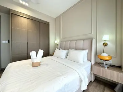a bedroom with a large white bed with a basket on it at Agile Bukit Bintang TRX KL by Lilbean Space - 2B1R in Kuala Lumpur