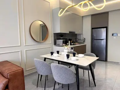 a dining room with a table and chairs and a mirror at Agile Bukit Bintang TRX KL by Lilbean Space - 2B1R in Kuala Lumpur