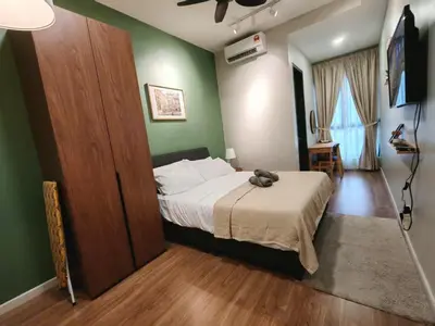 a bedroom with a bed and a green wall at Sunway Velocity Two Direct Link to Sunway Velocity Mall MRT TRX in Kuala Lumpur