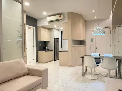 a kitchen and living room with a couch and a table at The Robertson Bukit Bintang in Kuala Lumpur