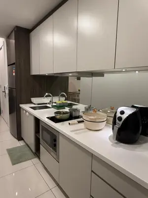 a kitchen with white cabinets and a counter top at The Robertson Bukit Bintang in Kuala Lumpur