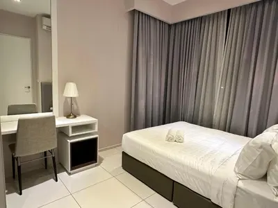 a hotel room with a bed and a desk with a computer at The Robertson Bukit Bintang in Kuala Lumpur