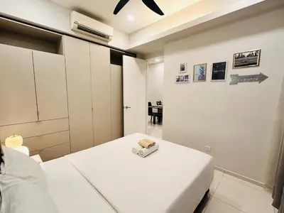 a bedroom with a white bed and a table at The Robertson Bukit Bintang in Kuala Lumpur