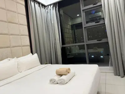 a bedroom with a bed with two towels on it at The Robertson Bukit Bintang in Kuala Lumpur