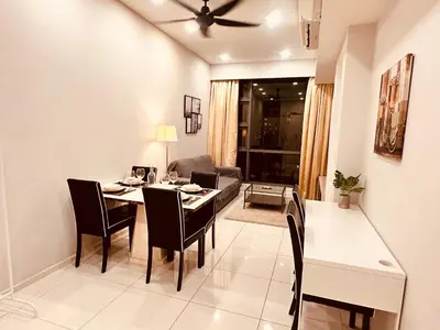 a dining room and living room with a table and chairs at The Robertson Bukit Bintang in Kuala Lumpur