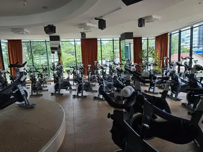 a gym with rows of treadmills and exercise bikes at MidValley Bangsar Stylish Suite by DingDing in Kuala Lumpur