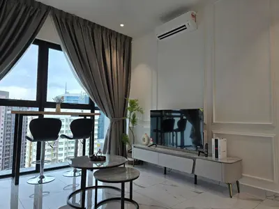 a living room with a tv and a table and chairs at MidValley Bangsar Stylish Suite by DingDing in Kuala Lumpur