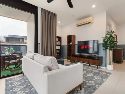 a living room with a white couch and a tv at Arcoris Soho 163 Mall Luxury 2Bedroom With City View in Kuala Lumpur