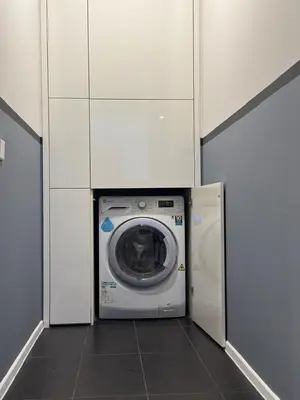 a washing machine in a room with white cabinets at Arcoris Soho 163 Mall Luxury 2Bedroom With City View in Kuala Lumpur