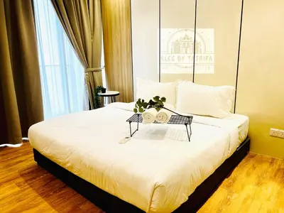 a bedroom with a large bed with a table at The Luxury Quill Residence KLCC By Tasrifa in Kuala Lumpur