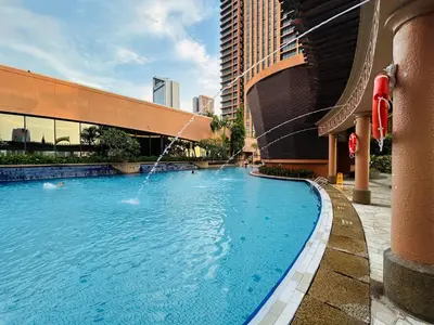 a pool with a water fountain in a building at DYNAMIC SUITES by TIMES SQUARE KL in Kuala Lumpur